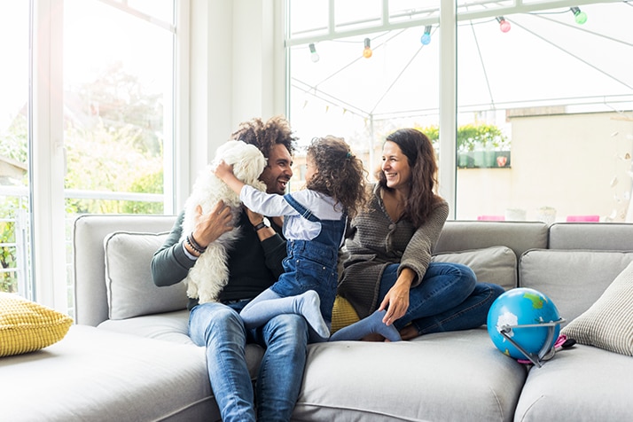 pais bricando com sua filha na sala de estar