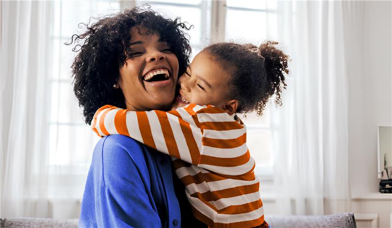 Mulher sendo abraçada por filha no dia das mães