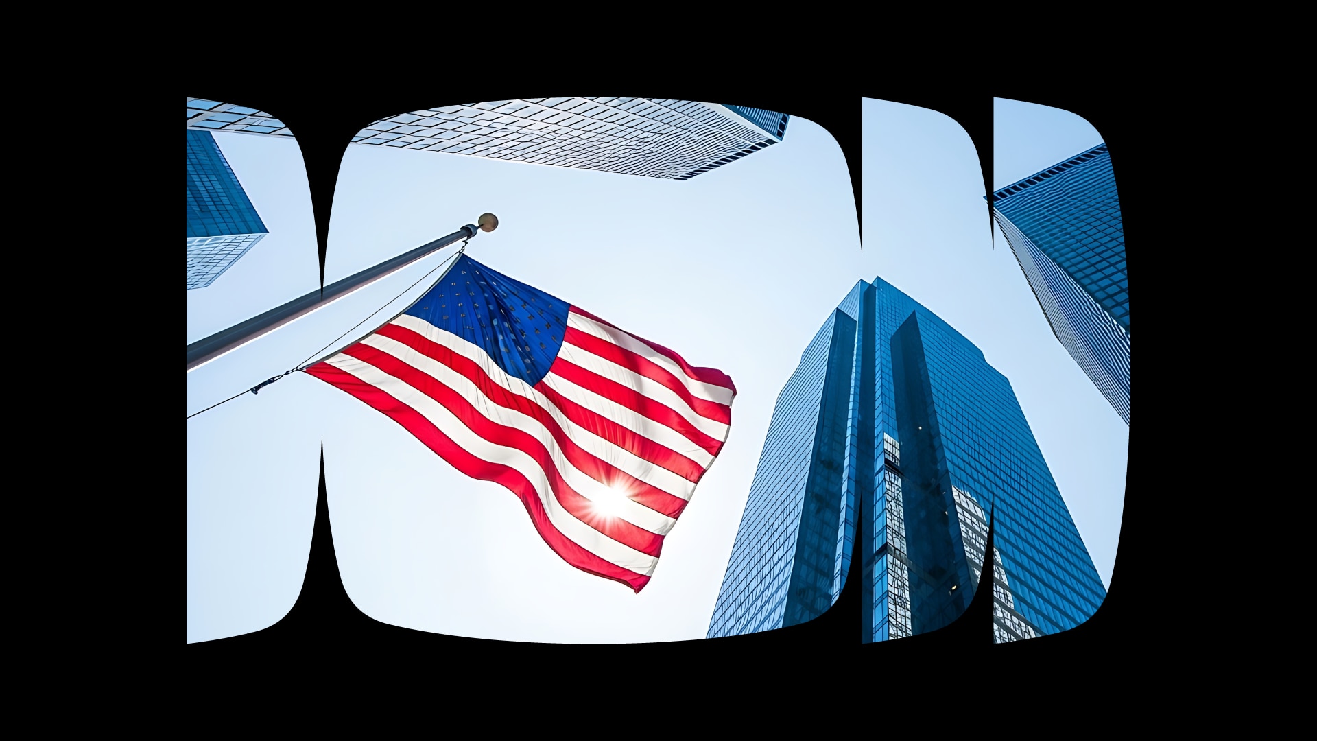Foto de uma bandeira dos Estados Unidos em meio a prédios corporativos espelhados com um céu azul ao fundo