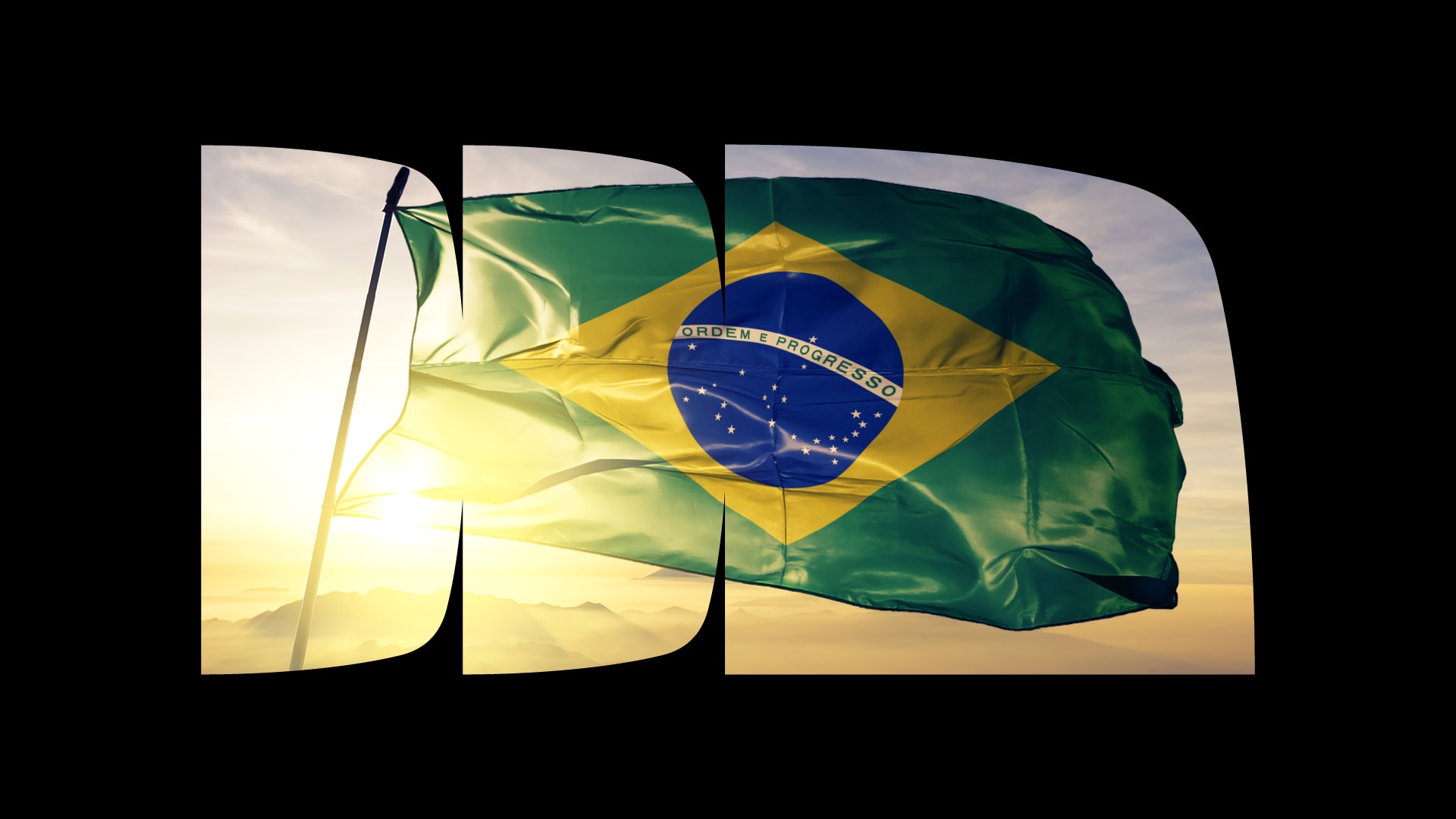 Imagem da bandeira do Brasil tremulando em frente a um céu ensolarado de fim de tarde dentro de recortes do logo do Itaú cercado por um fundo preto.